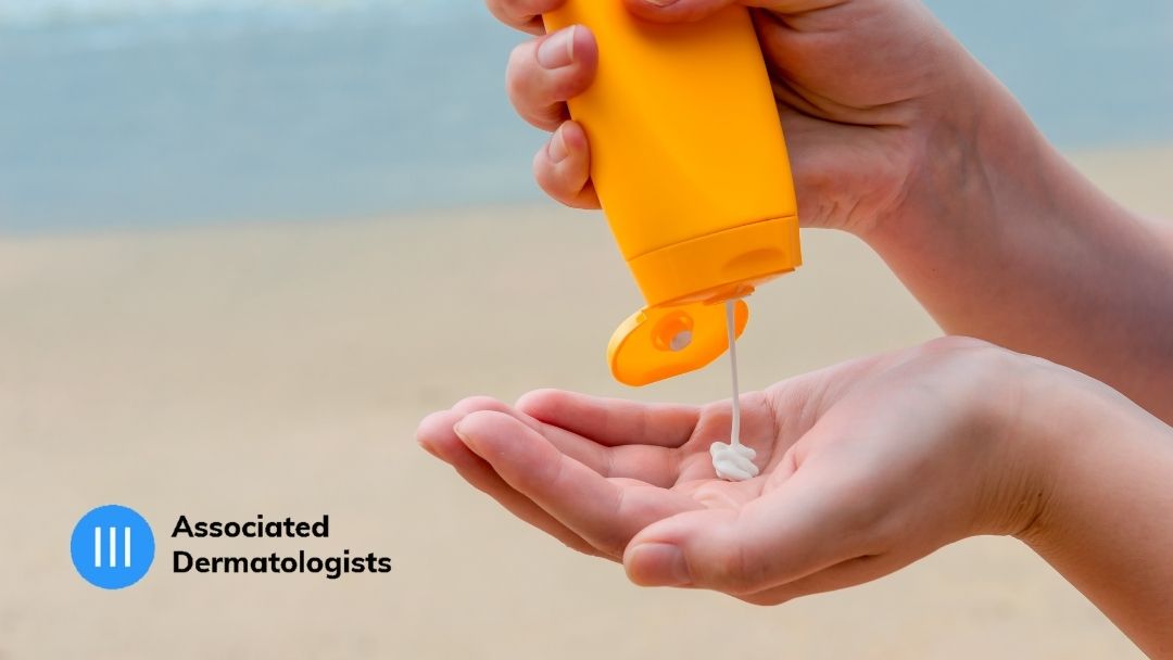 A person applying sunscreen at the beach.